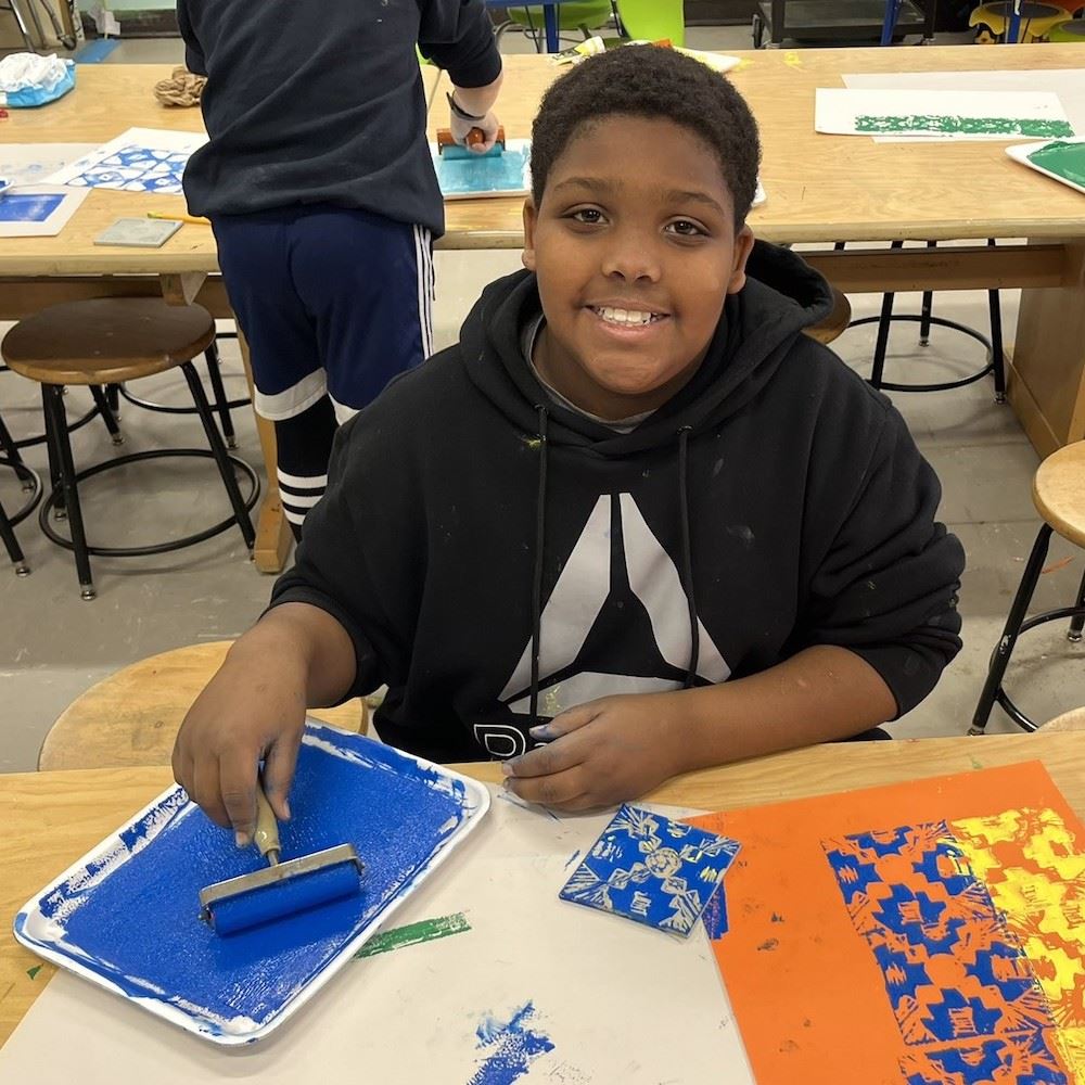  boy painting at a table